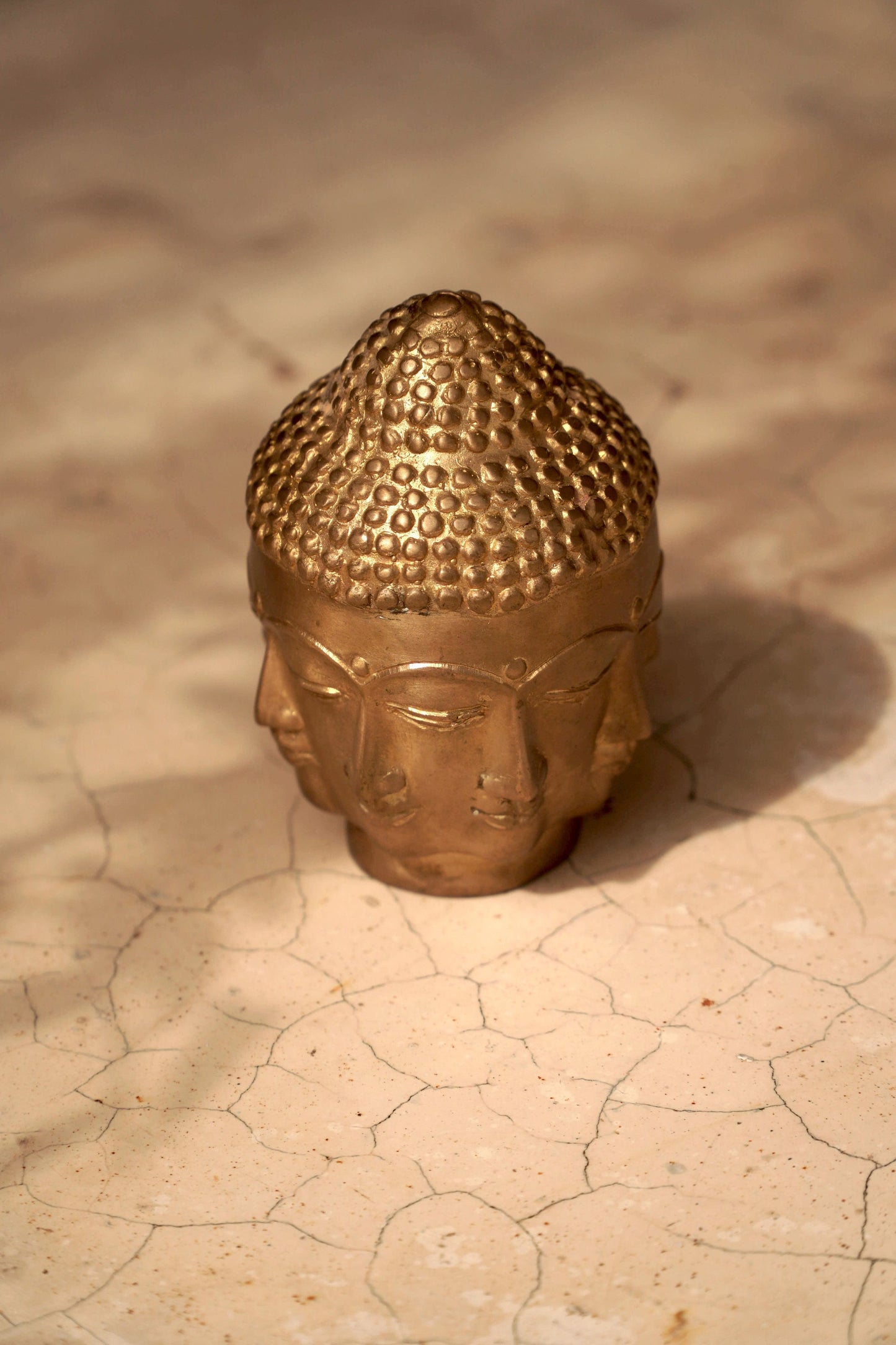 Brass Buddha head with a gaze in all directions